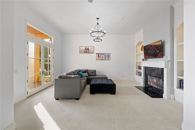 43840 E Vallejo Ave, Temecula, CA 92592 - carpeted living area featuring a chandelier, built in shelves, and a premium fireplace