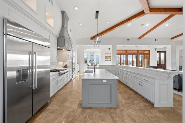 43840 E Vallejo Ave, Temecula, CA 92592 - kitchen with stainless steel appliances, a large island with sink, healthy amount of natural light, arched walkways, and recessed lighting