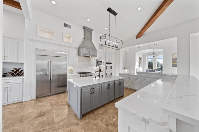 43840 E Vallejo Ave, Temecula, CA 92592 - kitchen with built in appliances, gray cabinetry, decorative backsplash, a sink, and a spacious island