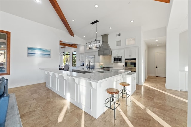 43840 E Vallejo Ave, Temecula, CA 92592 - kitchen with custom range hood, stainless steel appliances, a breakfast bar, recessed lighting, and a large island