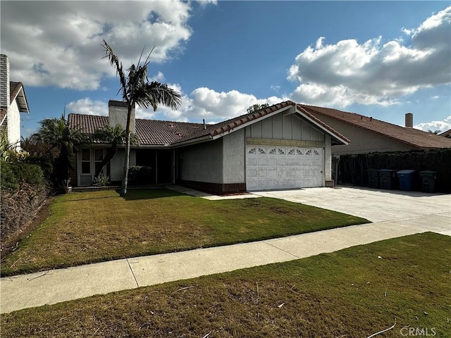 view of front of home with driveway, a garage, a tiled roof, and a front lawn