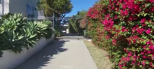 view of property's community with fence and a gate