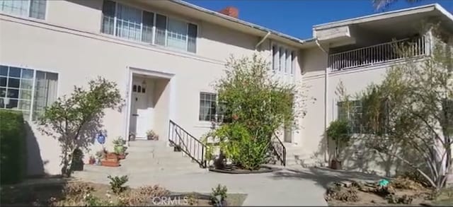 back of property with stucco siding