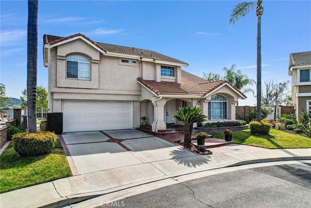 view of front of home with a garage, driveway, stucco siding, a tile roof, and fence