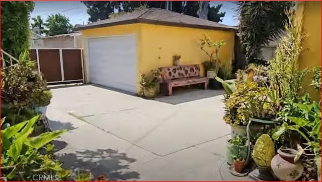 garage featuring concrete driveway