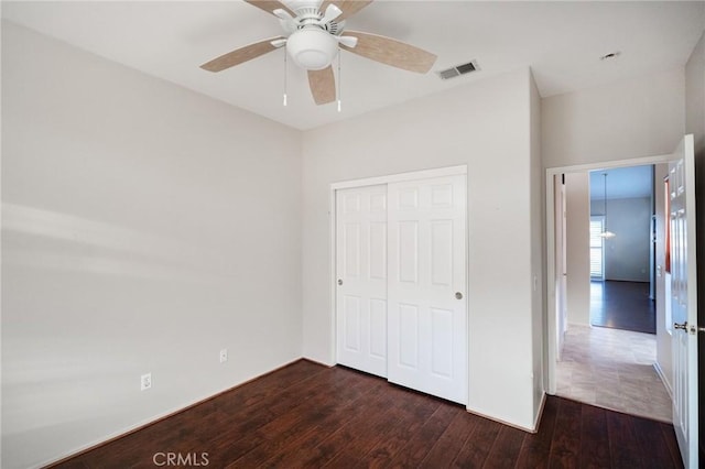 773 Camino De Plata, San Jacinto, CA 92583 - unfurnished bedroom with visible vents, dark wood-type flooring, a ceiling fan, and a closet