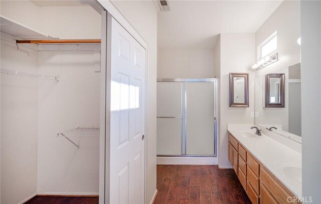 773 Camino De Plata, San Jacinto, CA 92583 - full bathroom with a sink, a shower stall, double vanity, and wood finished floors