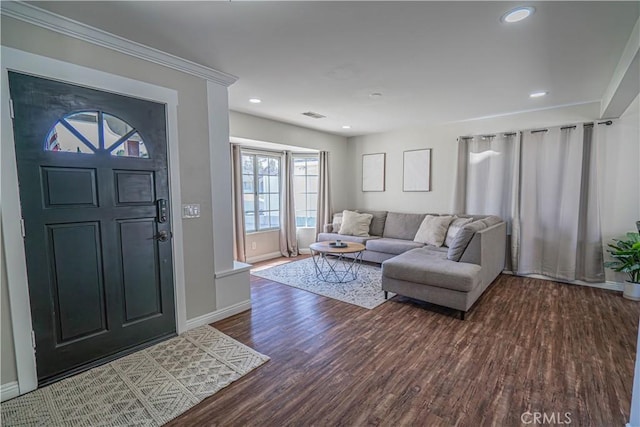 foyer with wood finished floors, baseboards, ornamental molding, visible vents, and recessed lighting