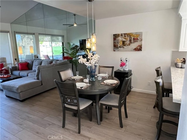 dining area with ceiling fan, baseboards, and wood finished floors