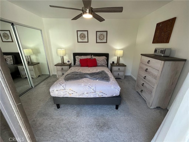 bedroom with carpet floors, a ceiling fan, baseboards, and a closet