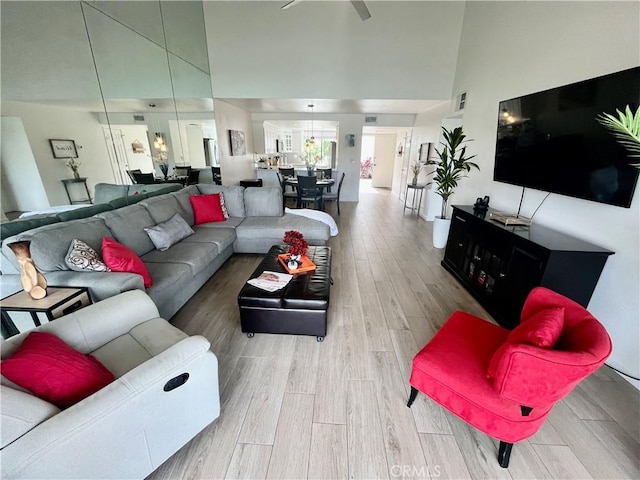 living room with a high ceiling and wood finished floors