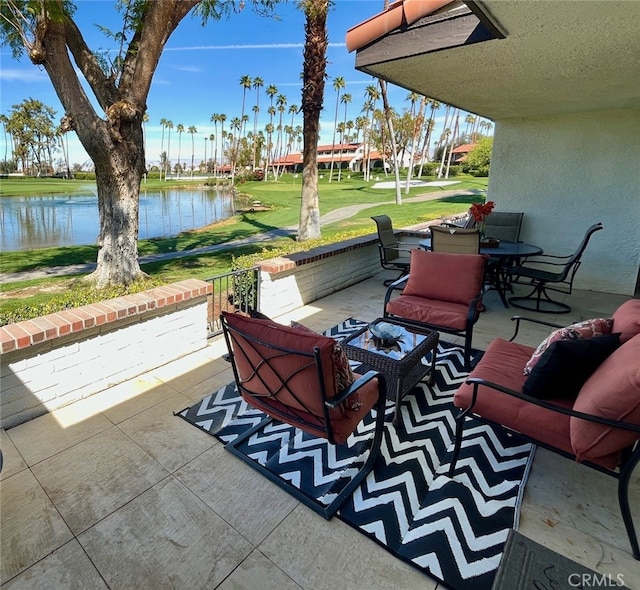 view of patio featuring outdoor dining space, a water view, and an outdoor hangout area