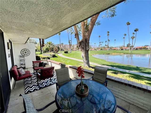 view of patio featuring outdoor dining area and a water view