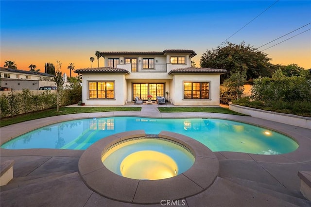 627 W Palm Dr, Arcadia, CA 91007 - back of house featuring a pool with connected hot tub, a patio, a balcony, stucco siding, and a tiled roof