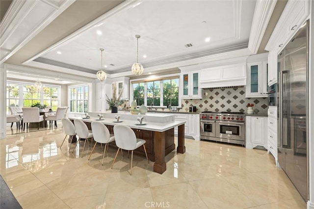 627 W Palm Dr, Arcadia, CA 91007 - kitchen featuring high end appliances, tasteful backsplash, crown molding, a tray ceiling, and white cabinets