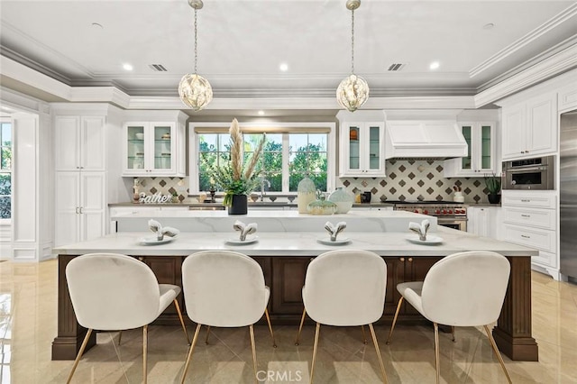 627 W Palm Dr, Arcadia, CA 91007 - kitchen featuring white cabinets, a breakfast bar area, appliances with stainless steel finishes, decorative backsplash, and custom range hood