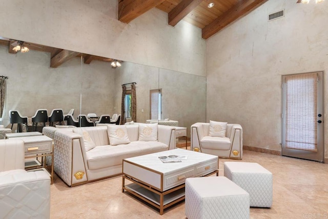 living area featuring visible vents, wooden ceiling, beam ceiling, and a high ceiling