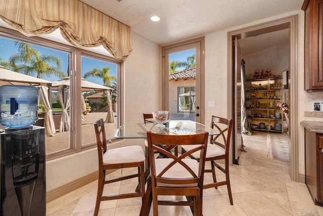 dining area with baseboards, recessed lighting, and a healthy amount of sunlight