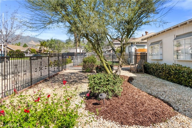 view of yard with fence and a mountain view