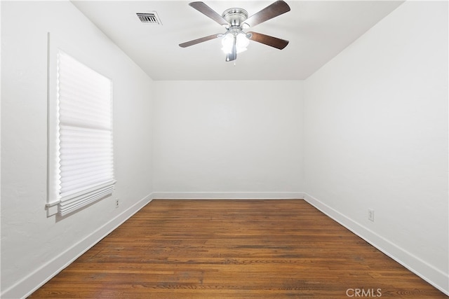 unfurnished room featuring baseboards, wood finished floors, visible vents, and ceiling fan