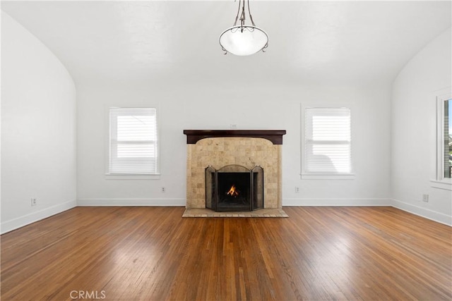 unfurnished living room with a wealth of natural light and wood finished floors