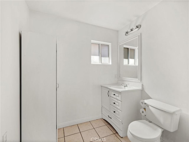 bathroom featuring tile patterned floors, toilet, vanity, and baseboards