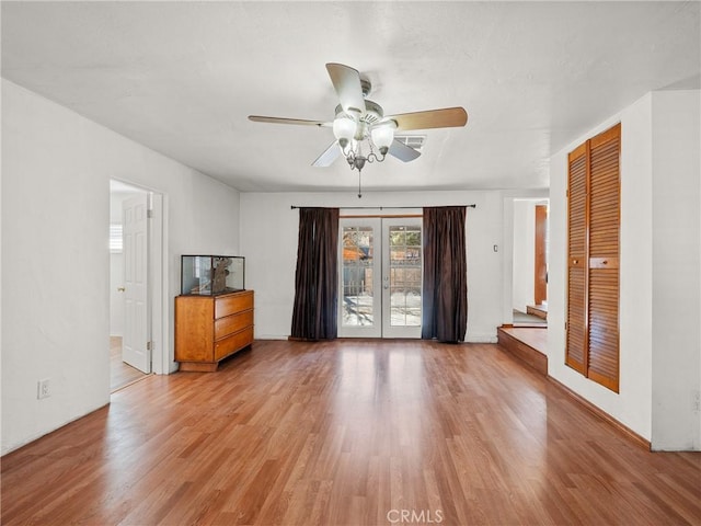 unfurnished living room with ceiling fan and wood finished floors