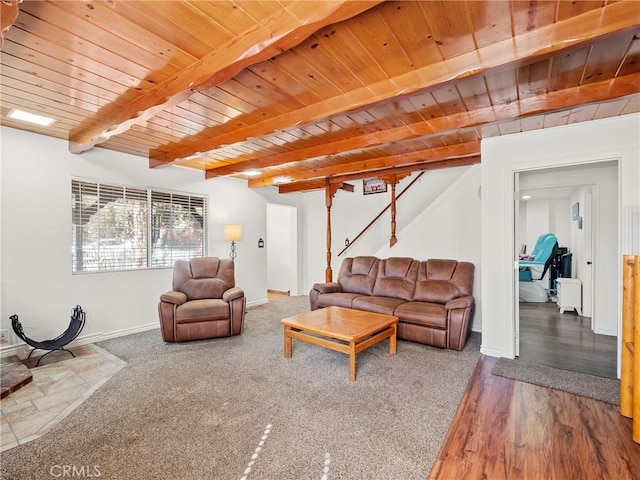 living area with baseboards, beamed ceiling, stairway, wood ceiling, and wood finished floors