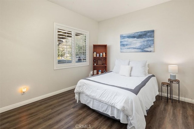 bedroom featuring dark wood finished floors and baseboards