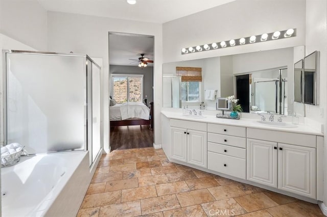 ensuite bathroom featuring a ceiling fan, a sink, a bath, and ensuite bathroom