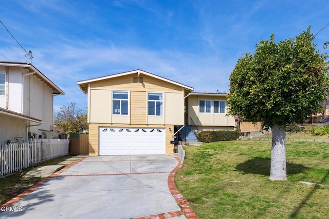 view of front of house featuring stucco siding, fence, a front lawn, driveway, and a garage