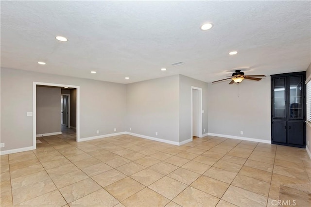 spare room with ceiling fan, light tile patterned floors, a textured ceiling, recessed lighting, and baseboards