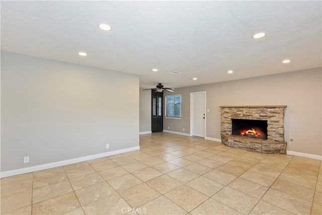 unfurnished living room with light tile patterned floors, a stone fireplace, recessed lighting, a ceiling fan, and baseboards