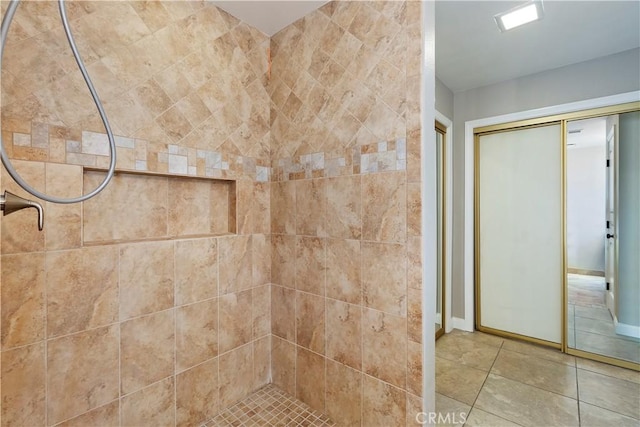 bathroom featuring tiled shower and tile patterned floors