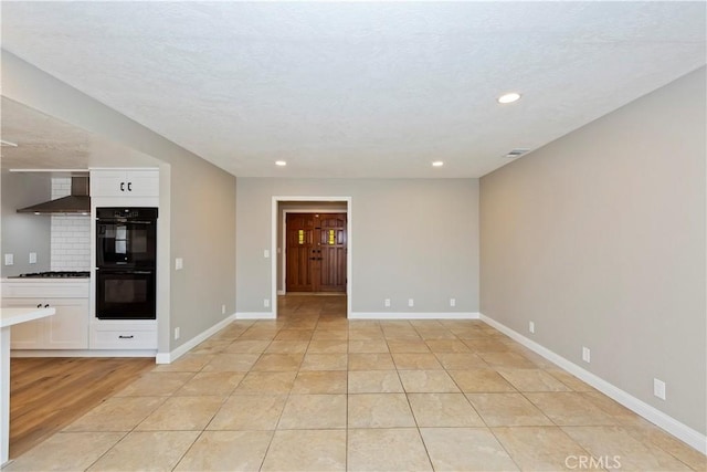 interior space with light tile patterned floors, recessed lighting, visible vents, and baseboards