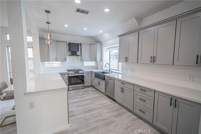 kitchen featuring visible vents, appliances with stainless steel finishes, hanging light fixtures, gray cabinets, and light countertops