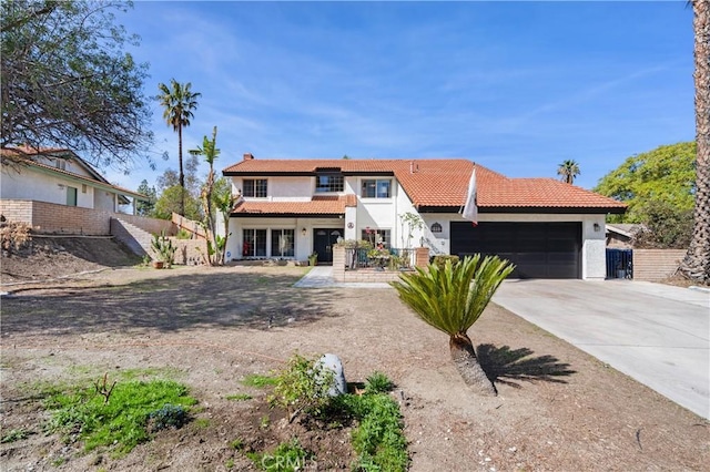 view of front of property featuring an attached garage, a balcony, concrete driveway, a tiled roof, and stucco siding