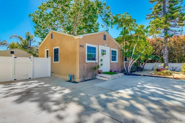 view of front facade featuring fence and stucco siding