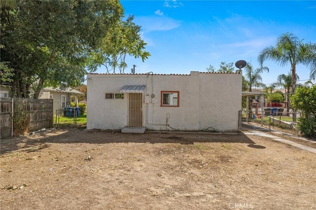 exterior space with fence and stucco siding