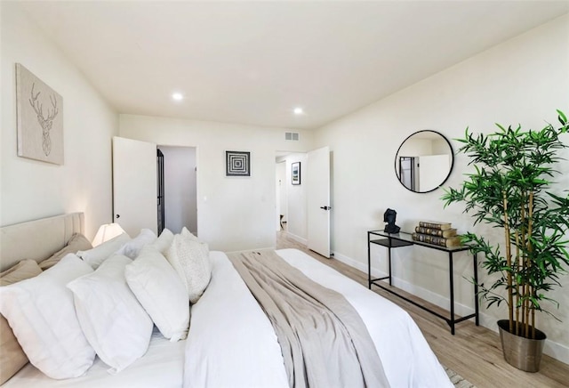 bedroom with light wood-type flooring, visible vents, baseboards, and recessed lighting