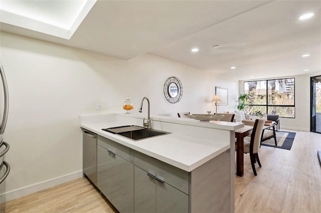 1745 Camino Palmero St Unit 537, Los Angeles, CA 90046 - kitchen featuring a peninsula, a sink, gray cabinetry, baseboards, and light wood-type flooring