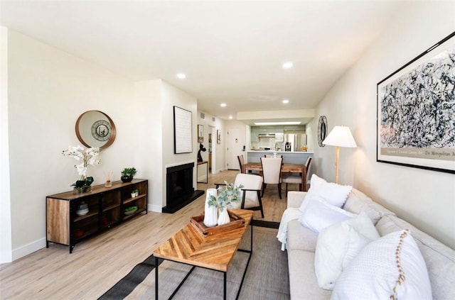 1745 Camino Palmero St Unit 537, Los Angeles, CA 90046 - living area featuring light wood-type flooring, recessed lighting, a fireplace with raised hearth, and baseboards