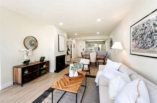 1745 Camino Palmero St Unit 537, Los Angeles, CA 90046 - living area featuring light wood-style flooring, recessed lighting, a fireplace with raised hearth, and baseboards