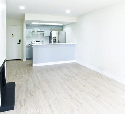 1745 Camino Palmero St Unit 537, Los Angeles, CA 90046 - unfurnished living room with light wood-style floors, baseboards, and recessed lighting