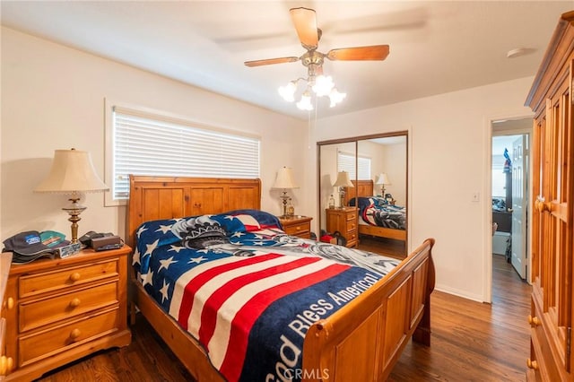 bedroom with baseboards, a closet, a ceiling fan, and dark wood-style flooring