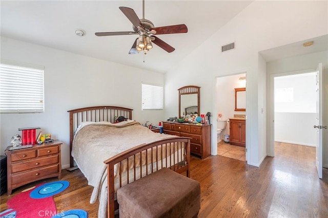 bedroom featuring ceiling fan, dark wood-type flooring, visible vents, baseboards, and vaulted ceiling