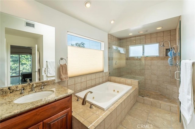 full bathroom featuring vanity, visible vents, a shower stall, a tub with jets, and ensuite bath