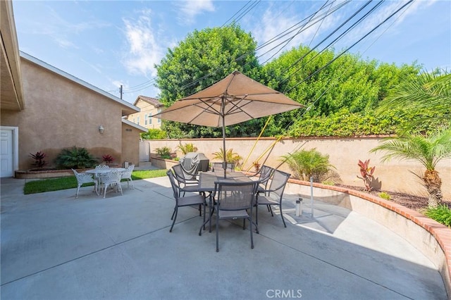 view of patio / terrace with outdoor dining space and a fenced backyard