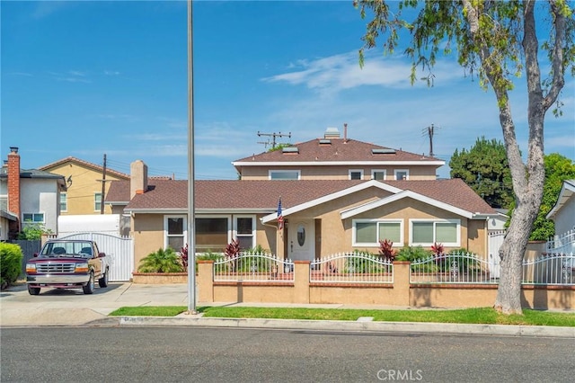 view of front facade featuring a fenced front yard and stucco siding