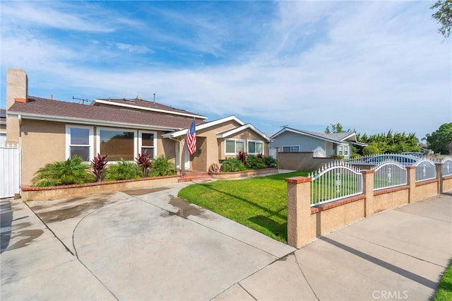 ranch-style house featuring a front lawn, a fenced front yard, a gate, and stucco siding